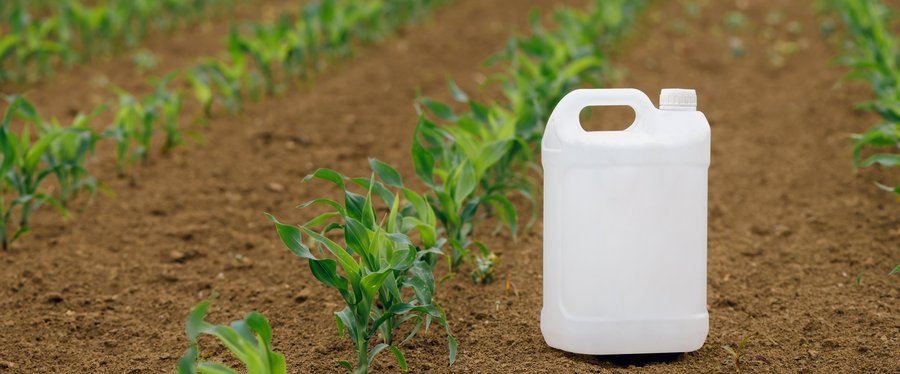 Corn pesticide canister in field, mock up
